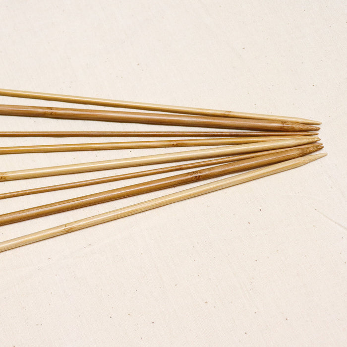 Phoenix gold bamboo straight knitting needles with sizes printed on.