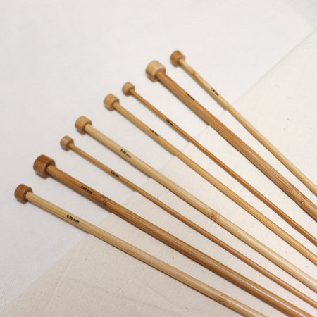 Phoenix gold bamboo straight knitting needles with sizes printed on.