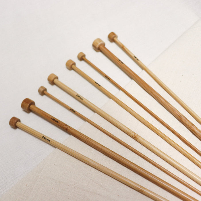 Phoenix gold bamboo straight knitting needles with sizes printed on.