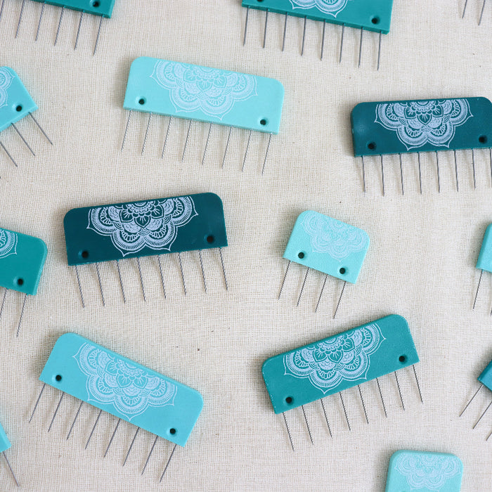 Knitpro midful collection knit blockers. teal plastic with a mandala design and metal pins.