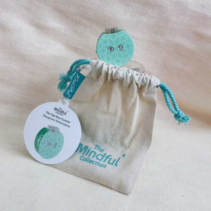 knitpro mindful collection teal row counter with mandala design and click button.