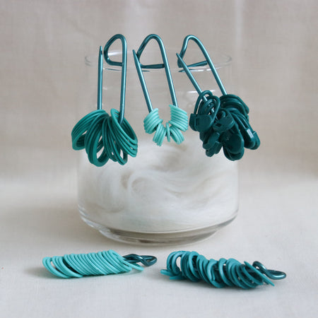 knitpro mindful collection teal stitch markers in 5 different shapes and styles.