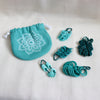 knitpro mindful collection teal stitch markers in 5 different shapes and styles.