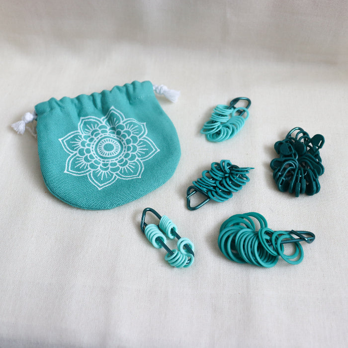 knitpro mindful collection teal stitch markers in 5 different shapes and styles.