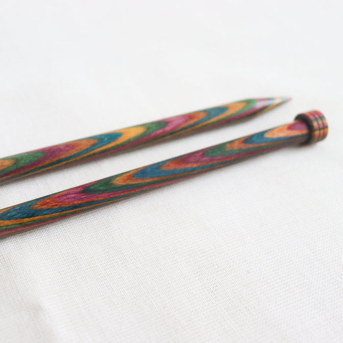 Symfonie single point straight knitting needles, made from multicoloured layered and laminated wood with sizes printed on the needles.