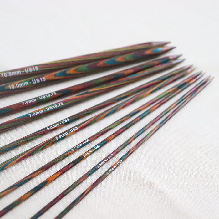 Symfonie single point straight knitting needles, made from multicoloured layered and laminated wood with sizes printed on the needles.