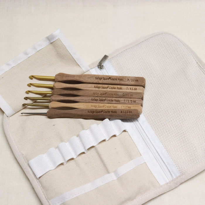 kollage square crochet hook set. Aluminium crochet hooks with a wooden handle in a black and white soft cloth pouch with elastic slots for hooks and zipped pouch.