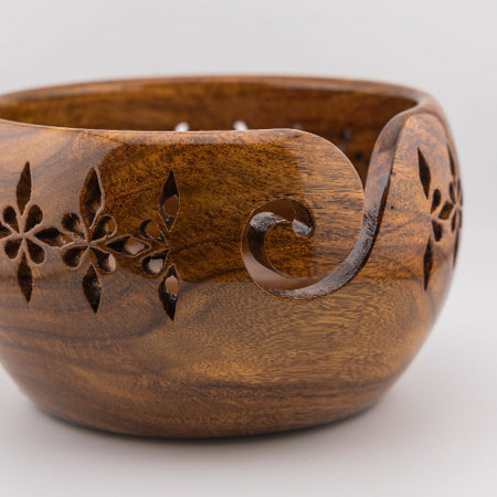 sheesham wood yarn bowl with geometric floral cut outs.